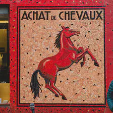 A tilled wall with a drawing of a horse and the title "Achat de Chevaux". Someone is standing on the right, not really happy.