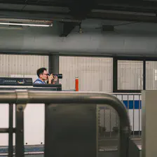 Someone is taking picture of train at a train platform