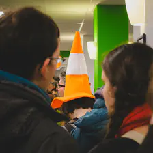 Someone with a VLC cone on their head queuing for coffee. 