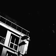 Picture of a building corner taken from below. It is highly contrasted with near black and near white colors.
https://www.flickr.com/photos/ztec/53132785349/