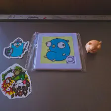 Swag from the Golang room. A sticker, a Puzzle, and a 3d printed figurine. All of a Golang Gopher. 