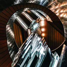 A circular stairway with a model squared crystals handing in the middle. Taken at Národní divadlo
https://www.flickr.com/photos/ztec/53163959003/