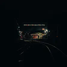 A train station in the middle is visible in the dark