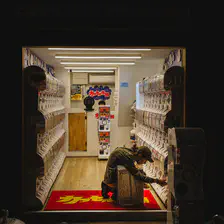 Someone is playing Gashapon in a small shop full of it