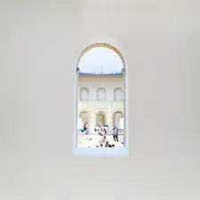People visible though a hole in a wall in a museum