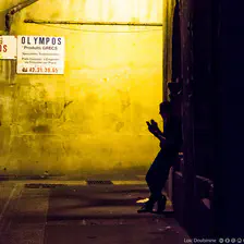 A worker is taking a break with his phone and a cigatrette in the dark of the light !
https://www.flickr.com/photos/ztec/9517446550/