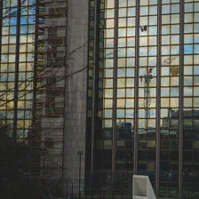 A Palestinian flag hanging of a window on a small sky scraper in from of the ULB Brussel. 