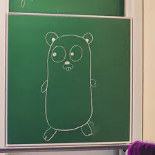 The go dev room traditional gopher drawn on the board